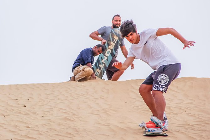 Classic Dubai Desert Safari with BBQ Dinner and Camp activities - Camp time at sunset: camel rides, sandboarding, and henna