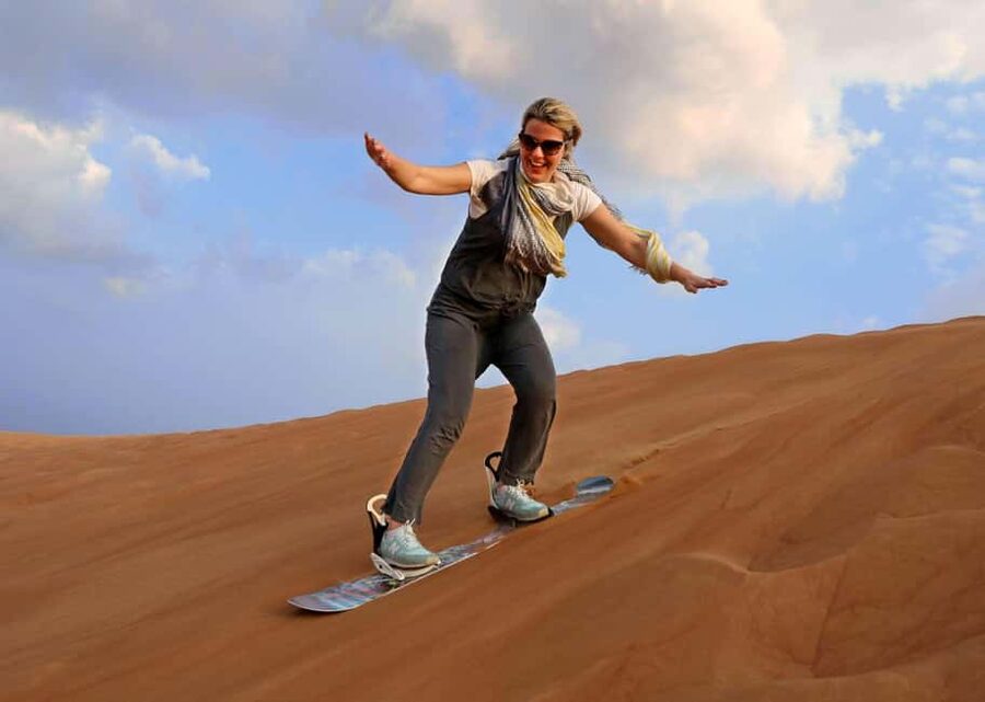 Desert Safari Dubai with Camel Ride, Sandboarding & Dinner - Sandboarding at Al Aweer: snowboarding energy, desert rules