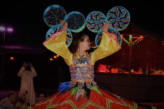 Desert Safari Red Dunes with Camel Ride, Sandboard, BBQ and Shows - Live performances at the camp: tanoura, belly dance, and fire