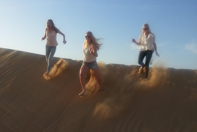 Dubai Desert Afternoon Quad Safari with Camel Ride, BBQ Dinner and Belly Dancing - Bedouin-style camp at night: coffee, shisha, henna, and sand art