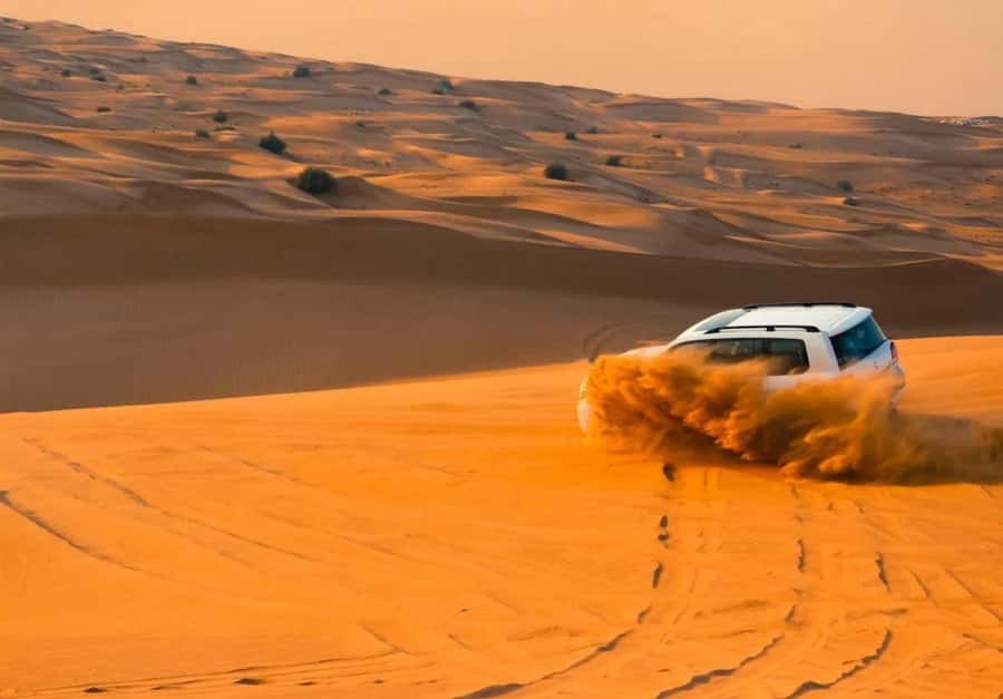 Dubai: Desert Safari, Camel Ride, Sandboard & Buffet Dinner - From hotel pickup to dune bashing in a 4x4