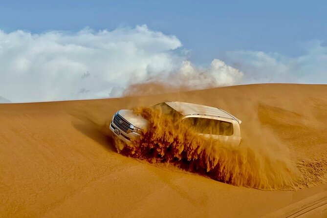Dubai Desert Safari: Dune Bashing, Camel Ride, Sandsurf & 5<em> BBQ – Key highlights worth planning for’ /></p>
<ul>
<li><strong>Long dune-bashing time in Lahbab</strong>, with photo and sandboarding pauses built into the route</li>
<li><strong>Sandboarding included</strong>, so you can try the full sandsurf-style action without extra booking</li>
<li><strong>Bedouin-style camp activities</strong>, including henna, local attire makeovers, and camel feeding</li>
<li><strong>Falcon expert moment</strong>, plus photos at the camp for a very “Dubai desert” memory</li>
<li><strong>Live shows in the evening</strong>, including Tanoura, fire show, belly dance, and Ladies Khaliji Dance</li>
<li><strong>Value add-ons are optional</strong>, like quad bikes or shisha, which cost extra</li>
</ul>
<div class="twil" style="margin: 20px 0; padding: 15px 0;"><p>Rougher drives we have been out on around Dubai</p><ul style="margin: 10px 0; padding-left: 0; list-style: none;"><li style="margin: 0 0 12px 0; padding: 0 0 12px 0; border-bottom: 1px solid #eee; line-height: 1.4;"><a href="https://uaetourreviews.com/dubai-desert-safari-dune-bashing-60min-atv-quad-camel-ride-bbq/">Dubai Desert Safari Dune Bashing, 60min ATV Quad, Camel Ride, BBQ</a><br><span style="font-size: 0.82em; color: #555;"><span style="color: #c2703a;">★</span> 5.0 &nbsp;&middot;&nbsp; 11,364 reviews</span></li><li style="margin: 0 0 12px 0; padding: 0 0 12px 0; border-bottom: 1px solid #eee; line-height: 1.4;"><a href="https://uaetourreviews.com/dubai-desert-safari-dune-bashing-camel-ride-sandboarding-bbq/">Dubai Desert Safari, Dune Bashing, Camel Ride, Sandboarding & BBQ</a><br><span style="font-size: 0.82em; color: #555;"><span style="color: #c2703a;">★</span> 5.0 &nbsp;&middot;&nbsp; 3,274 reviews</span></li><li style="margin: 0 0 12px 0; padding: 0 0 12px 0; border-bottom: 1px solid #eee; line-height: 1.4;"><a href="https://uaetourreviews.com/dubai-desert-safari-with-dune-bashing-camel-ride-bbq-dinner/">Dubai Desert Safari With Dune Bashing, Camel Ride & BBQ Dinner</a><br><span style="font-size: 0.82em; color: #555;"><span style="color: #c2703a;">★</span> 5.0 &nbsp;&middot;&nbsp; 3,245 reviews</span></li><li style="margin: 0; padding: 0; border-bottom: none; line-height: 1.4;"><a href="https://uaetourreviews.com/dubai-sandboarding-camel-ride-and-red-dune-bashing/">Dubai: Sandboarding, Camel Ride and Red Dune Bashing</a><br><span style="font-size: 0.82em; color: #555;"><span style="color: #c2703a;">★</span> 4.9 &nbsp;&middot;&nbsp; 2,367 reviews</span></li></ul></div><h2 id="luxury-pickup-to-lahbab-red-dunes-and-why-it-matters">Luxury pickup to Lahbab red dunes, and why it matters</h2>
<p><img width="669" height="446" decoding="async" src=