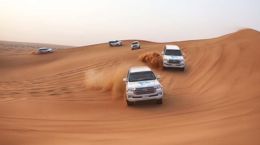 Dubai: Desert Safari with Camp, Dinner, & Optional Overnight - Dune bashing and sandboarding, the heart of the adrenaline