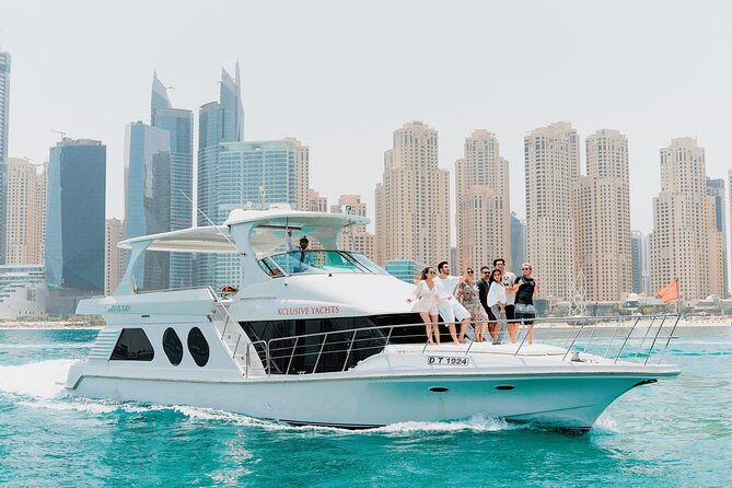 Dubai Marina 1hr Yacht tour with Drinks - Drinks, slow speeds, heat, and photo tips on an open-air deck