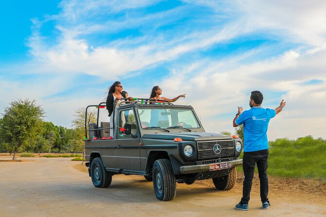 Dubai: Morning Safari by Vintage G Class & Al Marmoom Experience - The Bedouin village welcome: Arabic coffee, dates, luqaimat, and falcon photos