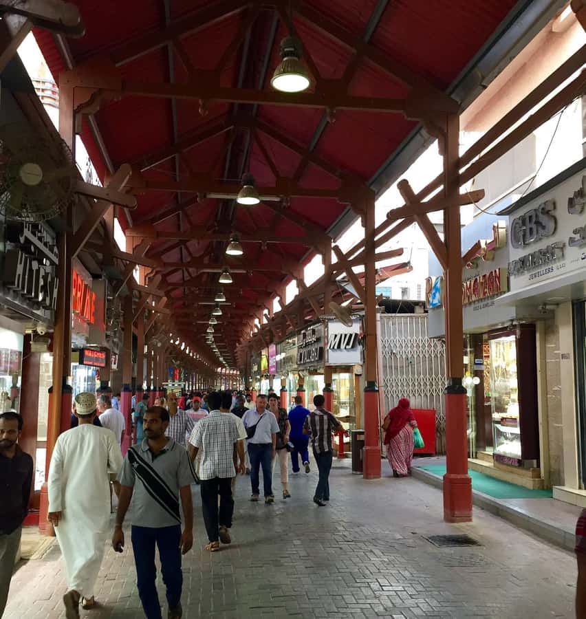 Dubai: Old City Walking Tour with Abra Ride - Al Fahidi Fort, Old Textile Market, and the Wind-Tower Streets