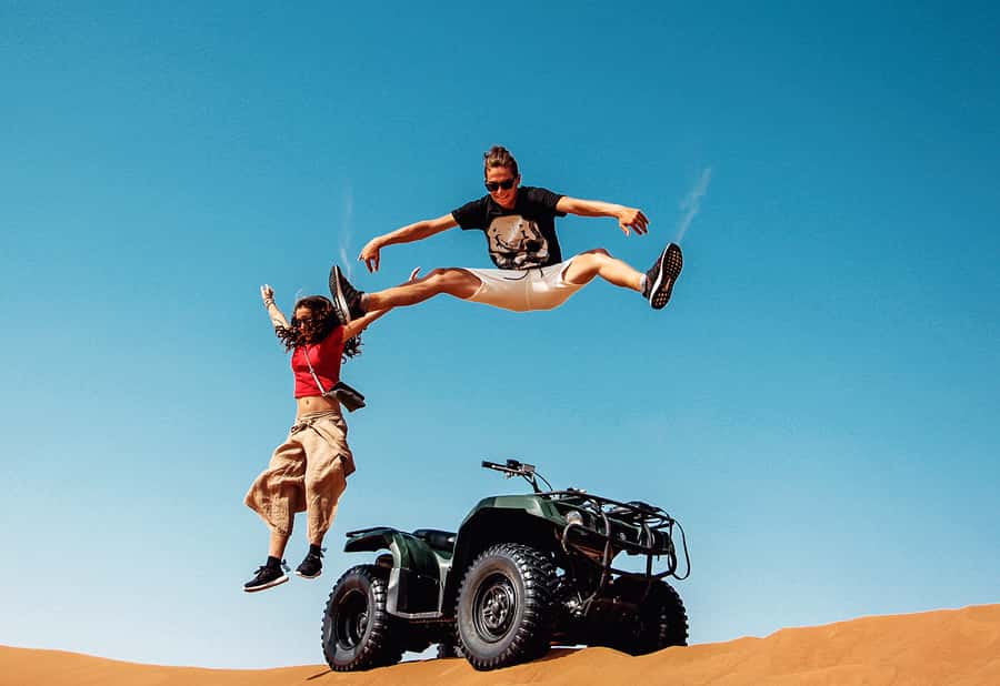 Dubai: Red Dunes Quad Bike with Sandboarding, Camels and BBQ - Pickup, air-conditioned pauses, and why timing matters in Dubai
