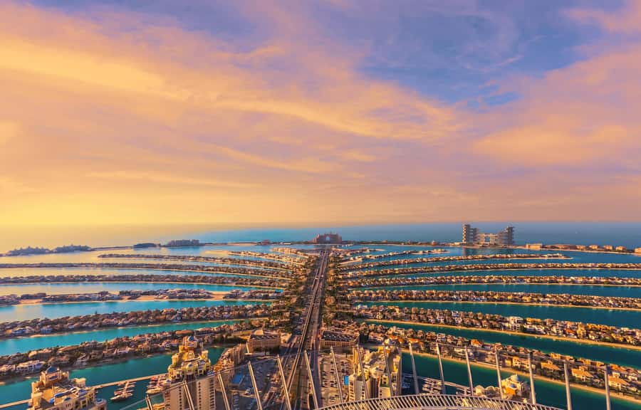 The Palm Jumeirah and the Dubai Marina skyline at sunset