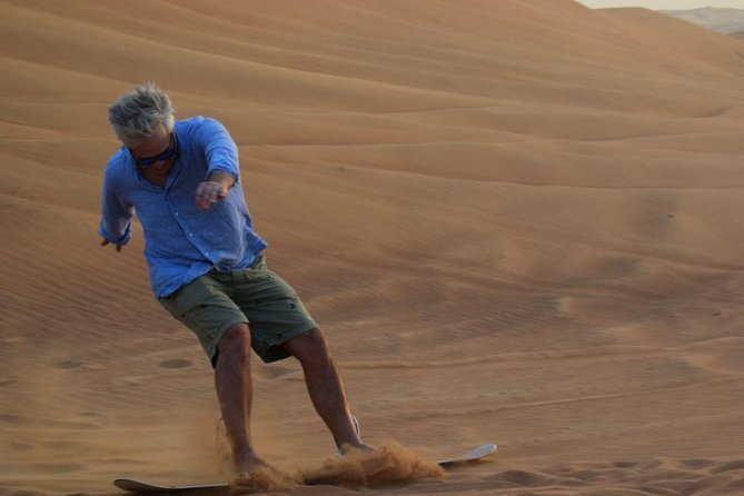 Dune Bashing with Quad Bike and Sand Boarding from Dubai - Sandboarding at base camp: the easy second thrill