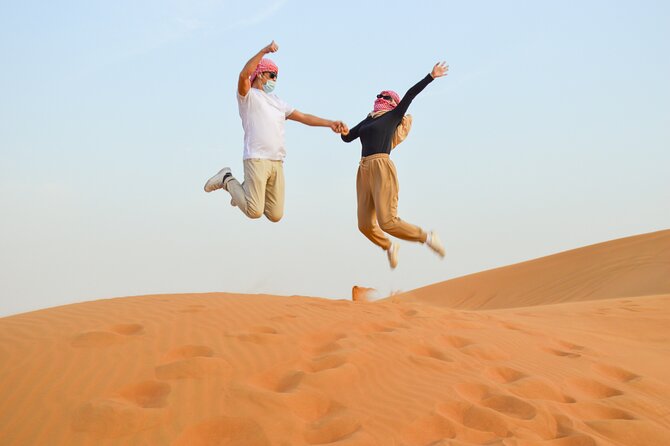 Evening Desert Safari with Quad Bike, BBQ Dinner and Camel Ride - Henna, Traditional Dress Photos, Falcon Moment, and Shisha Zone
