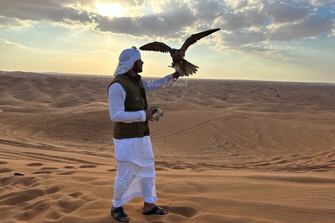 Experience the Ultimate Dubai Red Dunes Desert Safari BBQ Dinner - The 35 to 45 minutes dune bashing run, sandboarding, and falcon photos