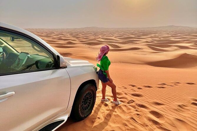 Full-Day Dubai Desert Safari Tour - Camp arrival: shisha, henna, falcon, and unlimited hot drinks