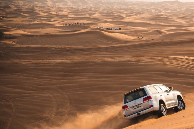 Full Day Safari Grand Adventures with Dune Bash on 4X4 in Dubai - Stop 1 at the Desert Camp: Camel Ride, Sandboarding, and Photo Breaks