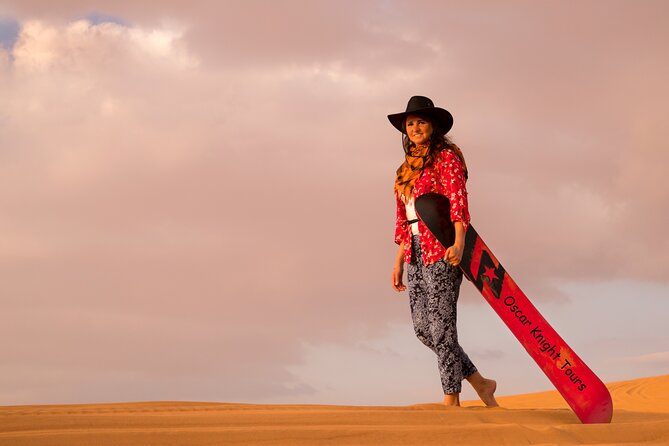 High Red Dunes with Camel Ride, Sandboarding, Falcon Show and VIP BBQ Dinner - Sandboarding: how to make the sliding part fun