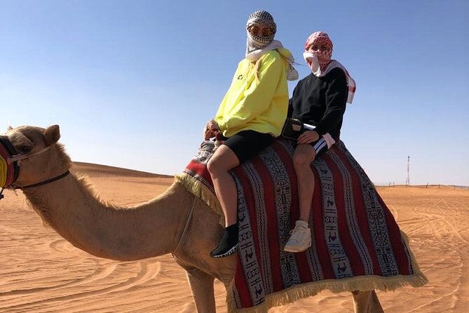 One hour Quad Bike at Red Sand Desert Safari with Camel Ride and BBQ Dinner - All-You-Can-Eat BBQ Dinner, Plus the Reality of Desert Dining