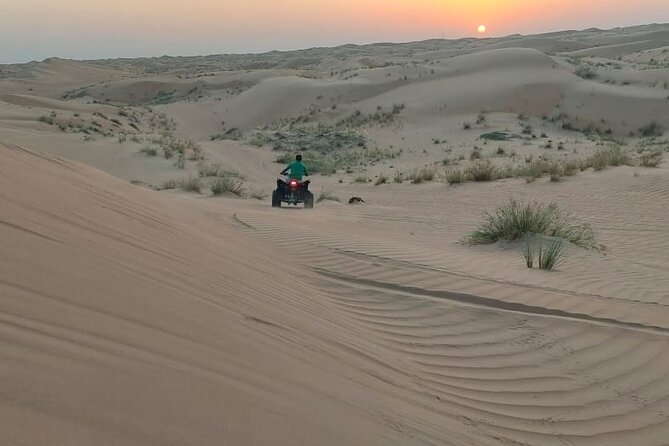 Private Quad Bike Tour through Deep Desert in Dubai - At the start point: getting on the bike without losing time